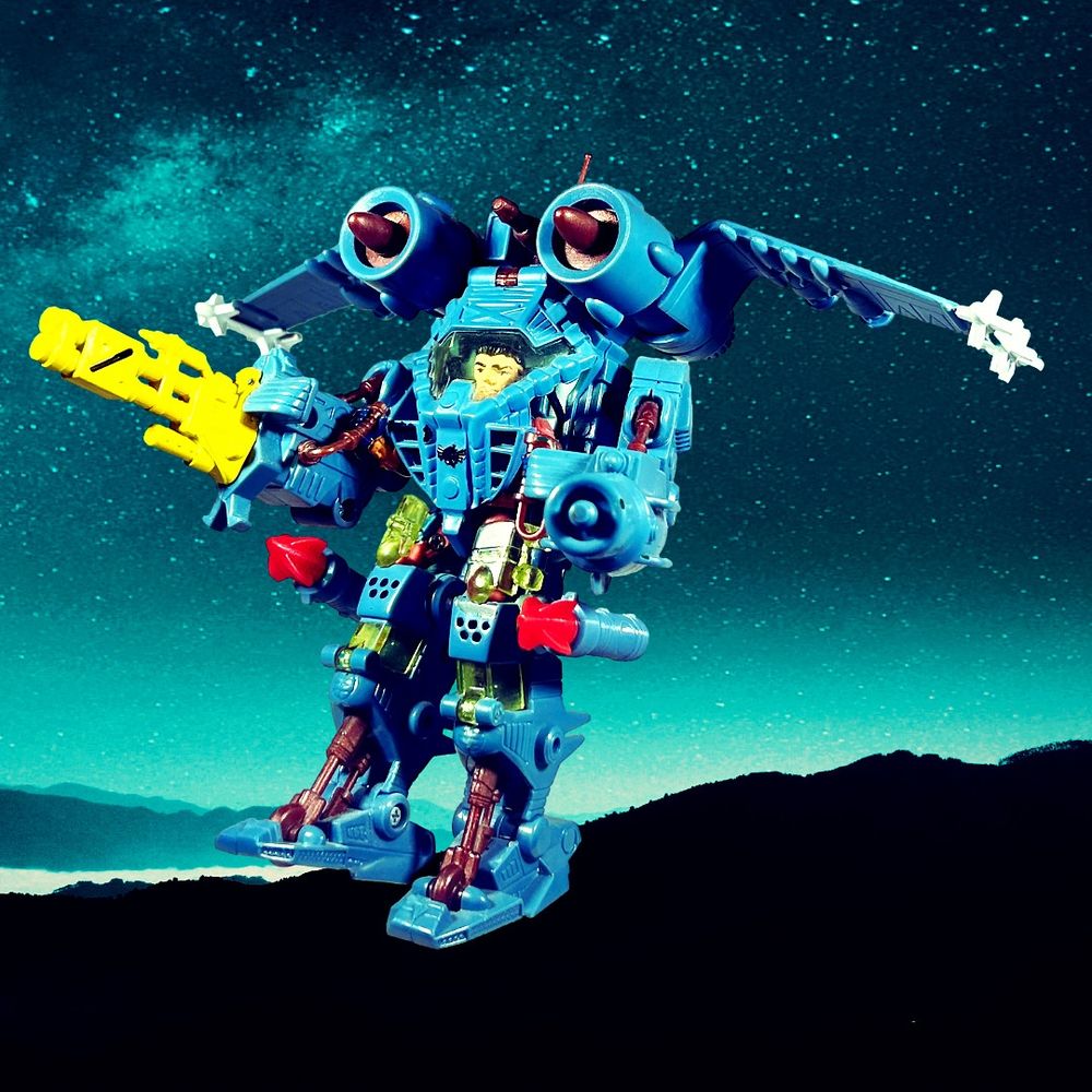 Action figure photo. It’s JT Marsh in his Aerial Assault E-Frame from Exosquad (technically the Tech Wars version) soaring over the night sky. Check out his cool new rocket pods!  