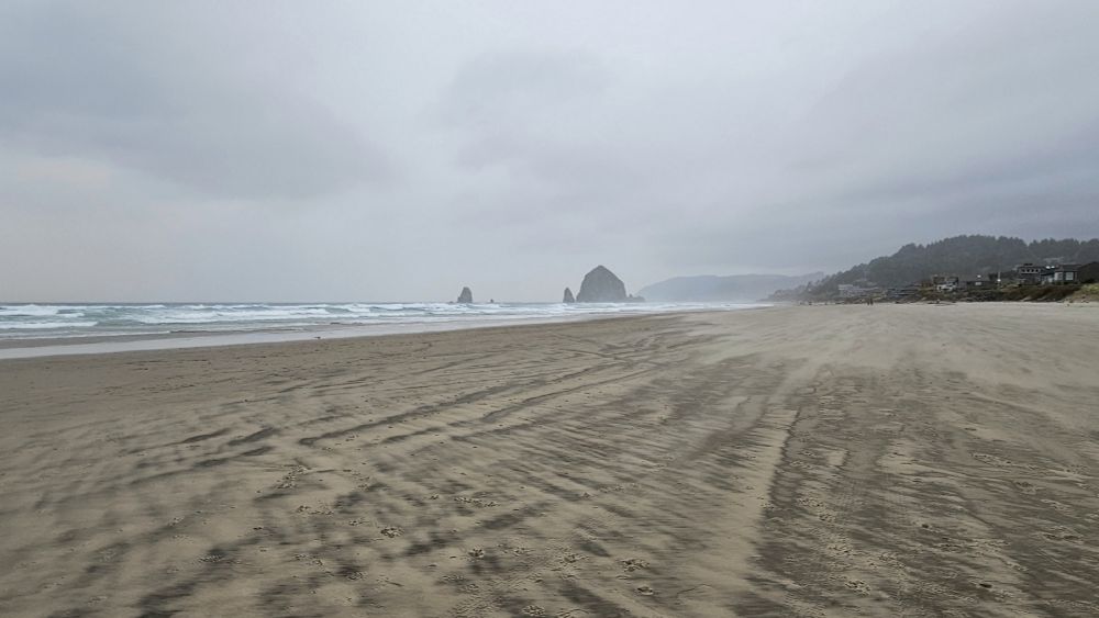Beach on the Oregon coast with Haystack Rock in the background.