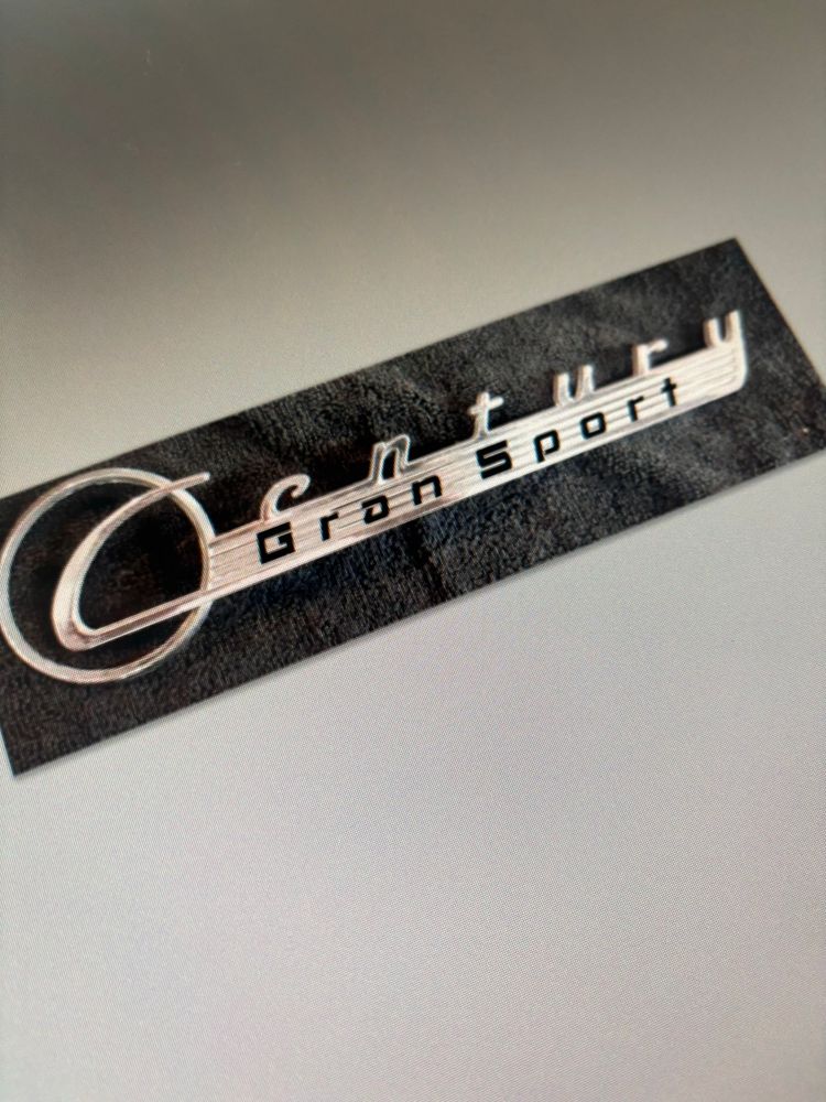 A photoshopped image of a 1955 Buck Century medallion modified to feature the phrase Gran Sport.