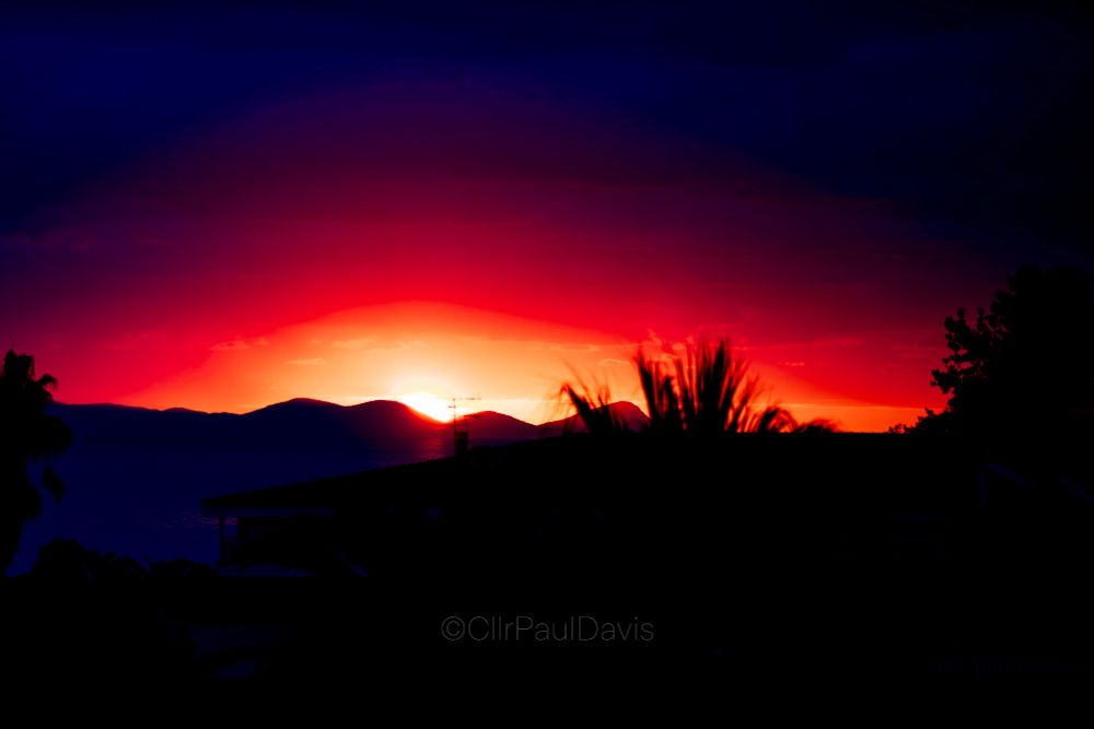 Very early moment in a sunrise viewed from the balcony of a hotel room in Kriopigi, Kassandra, Greece.  Photo has been saturated to bring out the fiery red hues as the night sky meets the morning.