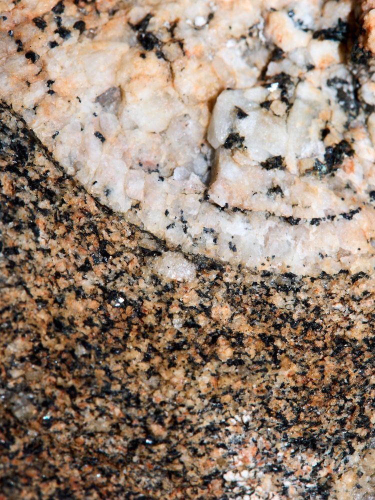 closer close up of difference between egg-shaped rock embedded in main rock