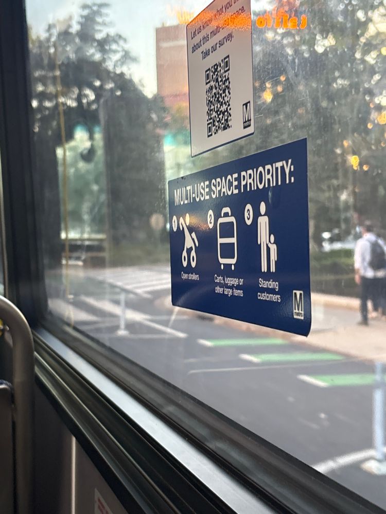 Sign indicating a multi-use space priority on a WMATA bus. It is a dedicated space for standing customers, customers with large items and strollers.