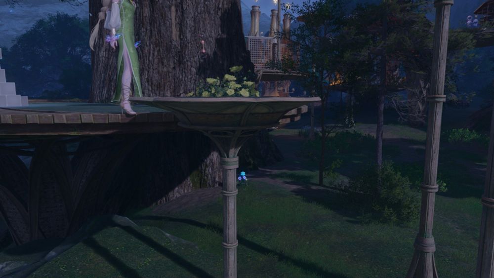 A forced perspective photo of yellow flowers in a tall vase.