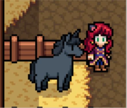 A close-up picture of a black unicorn in a barn stall.