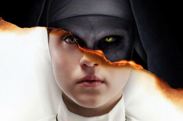 "The Nun" movie poster image of a split face. The top is of the demon nun, and the bottom is the main character, Irene, wearing her novitiate nun habit.