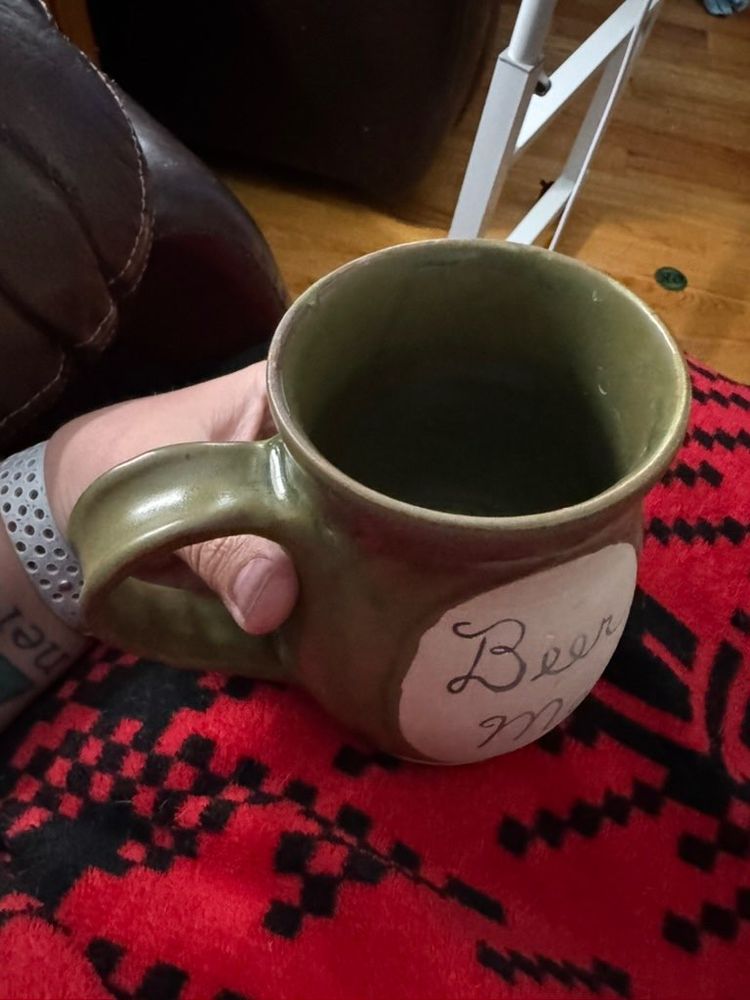 Ceramic mug with "Beer me" written in cursive using Mishima. Glazed in matcha.
