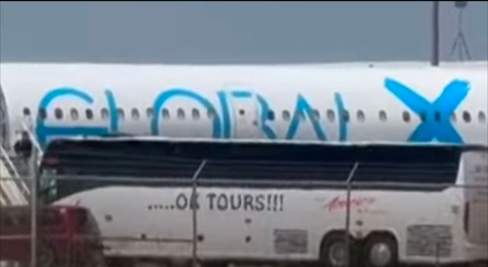Global X plane and OK TOURS bus waiting to transport children to Guatemala.