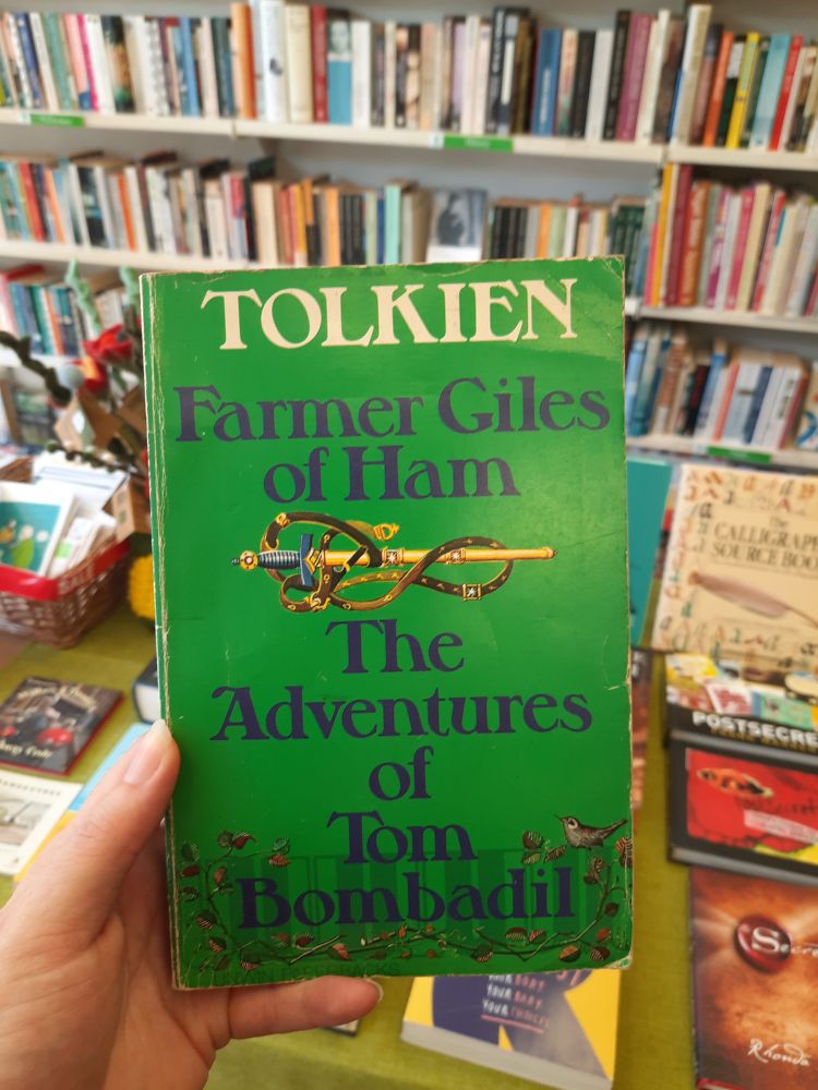 An old edition of farmer Giles and Tom bombadil book by tolkien in a 2nd hand bookshop 