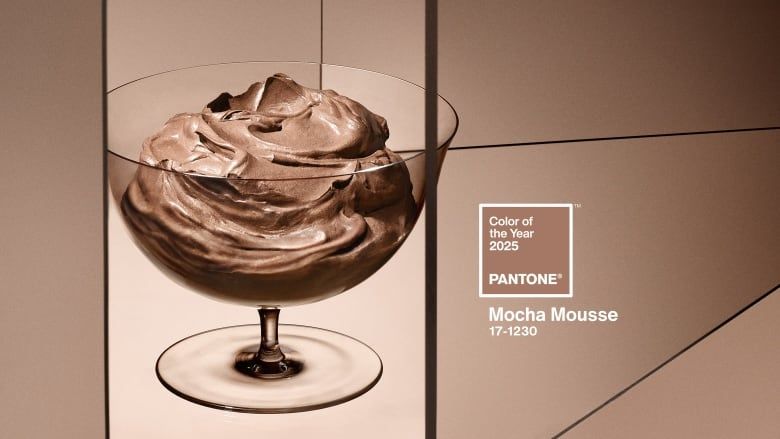 This image showcases Pantone's Color of the Year for 2025, "Mocha Mousse" (17-1230). The color is represented alongside an artistic depiction of chocolate mousse in a glass dessert dish. The backdrop features a modern, geometric design with soft, earthy tones complementing the main color.