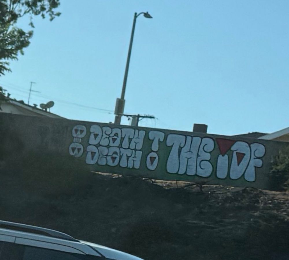 Graffiti on wall says “death death to the IDF”