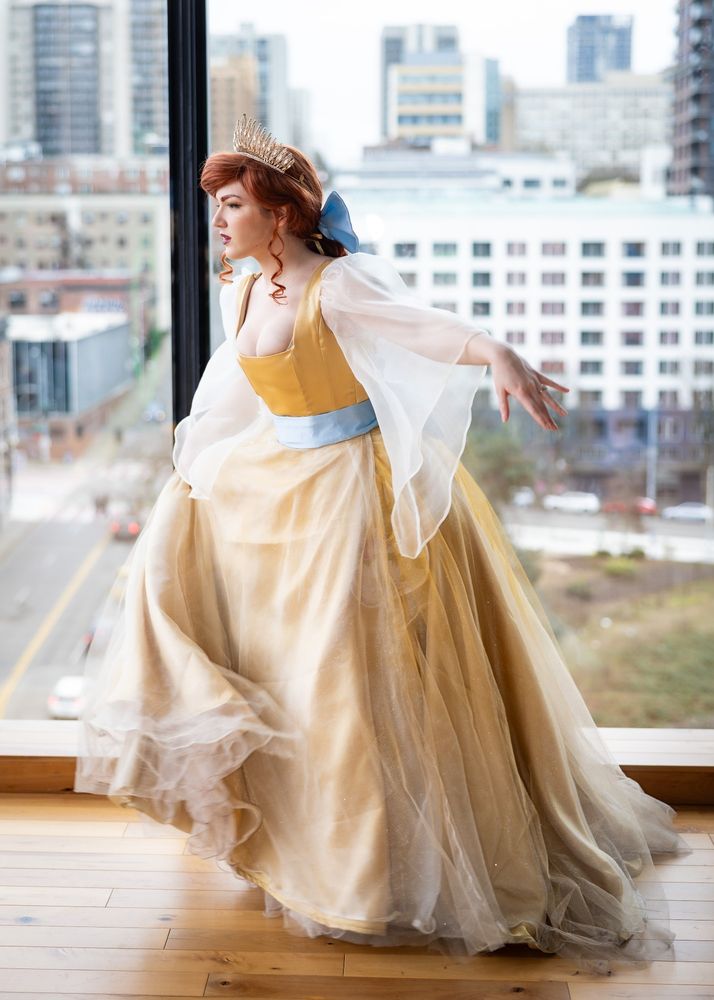 A cosplayer dressed as Anastasia from the 1997 animated movie during the song "Once Upon a December" curtseying. 