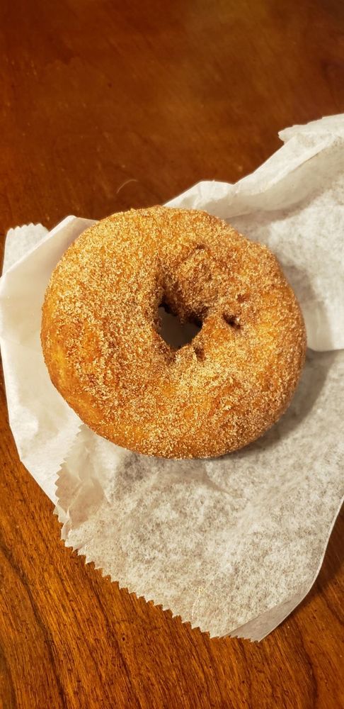 A cinnamon sugar donut on parchment paper 