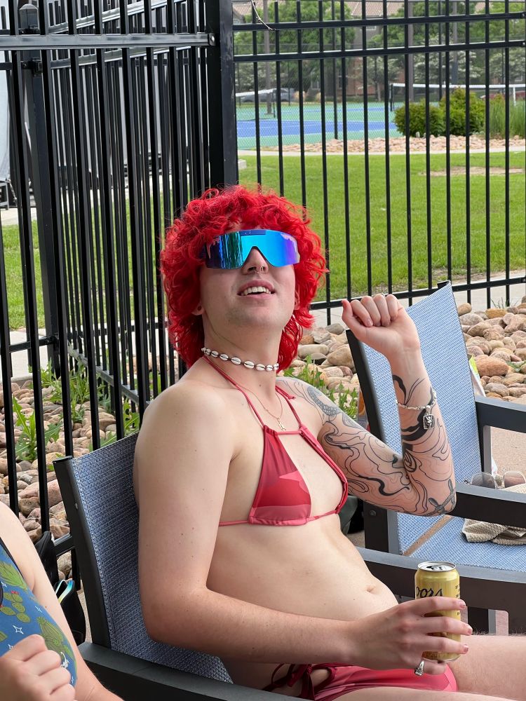 me in my 25th birthday in a red camo bikini, pukka shell necklace and big ole douche canoe sunglasses 