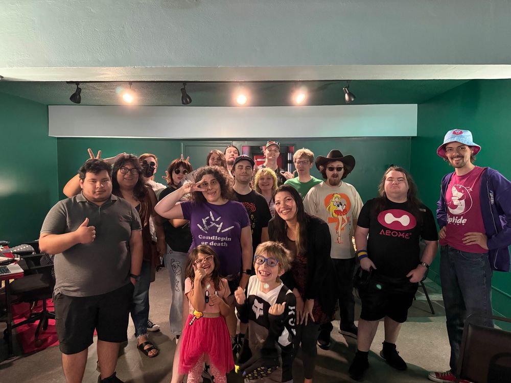 Many happy people at Left Click Lounge smile for a picture.