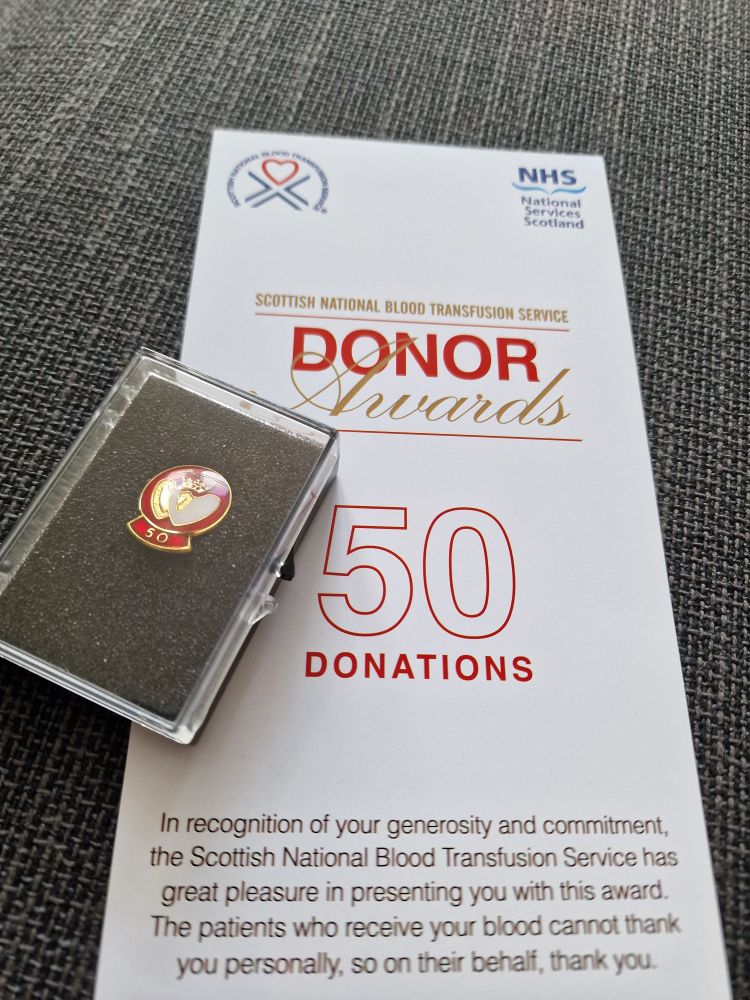 Picture of a 50th donation badge and certificate 