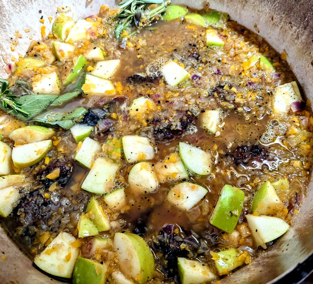 My Dutch Oven with the pork cheeks in it. You can see the granny smith apples that are cut into chunks, some of the sage leaves and bits of the pig cheeks poking through the broth.
It already smells amazing, I can't wait to see how it tastes!