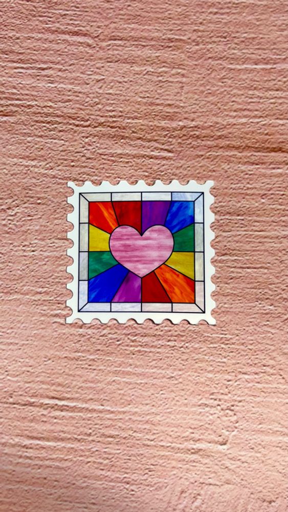 a stamp shaped sticker with a rainbow burst in the background. made to look like stained glass