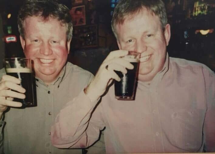 My dad and his identical twin both drinking Guinness 