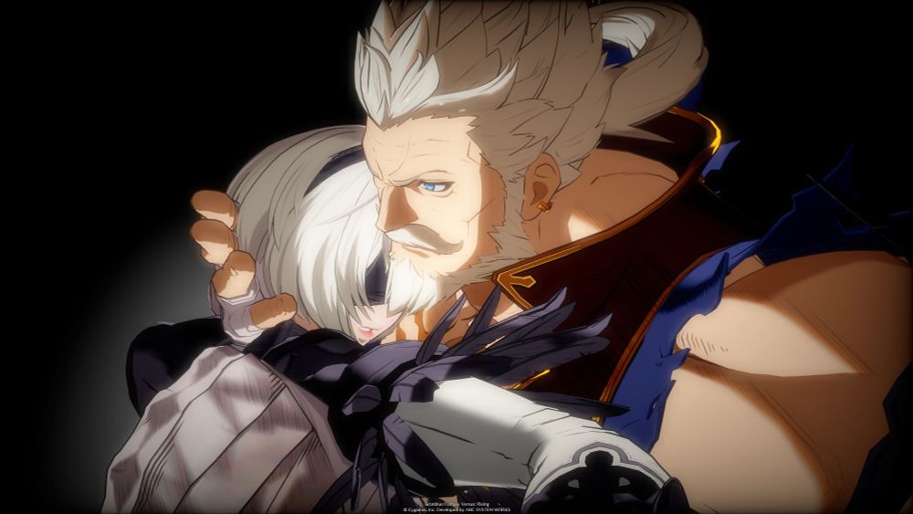 Soriz is gently holding 2B close to his chest and cradling her head. 2B's has a pained look on her face that would be difficult to make out unless anyone were close. There's a light gradient near 2B and a soft light filter on both of them.