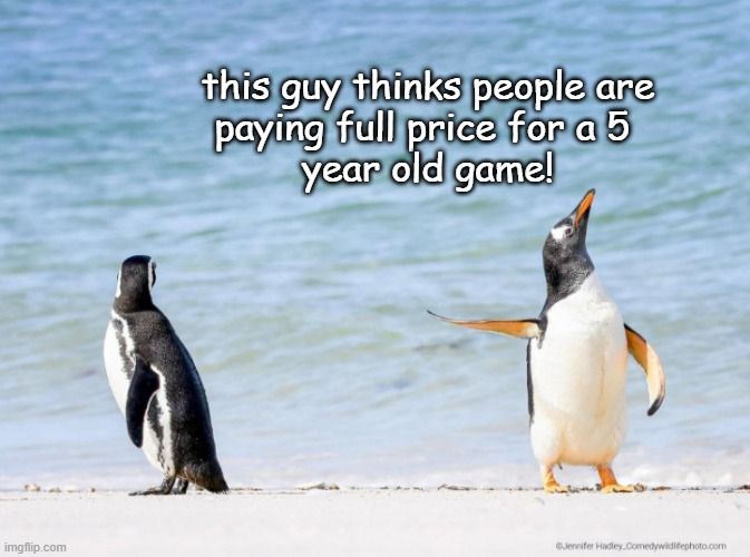 one penguin pointing at another penguio. the poiting penguin says 