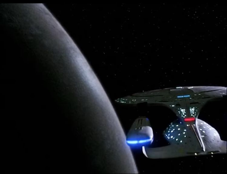 The Enterprise is approaching a Dyson Sphere 

The surface is much darker than most planet in Star Trek but there is clealry some external light source shining off it with no identification spice for the light 