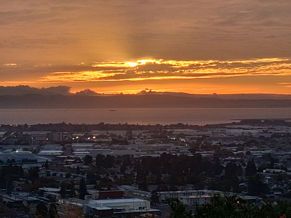 Sunset over the bay. Sky  streaked with gold.
