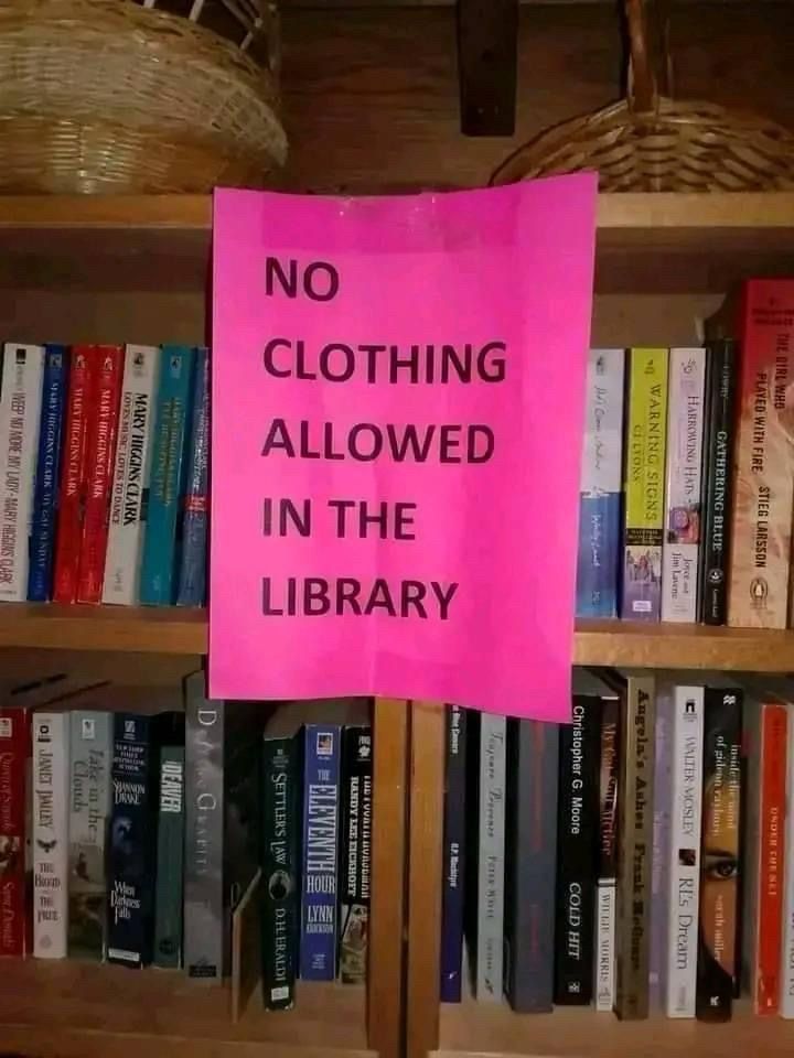 A sign reading “no clothing allowed in the library.”