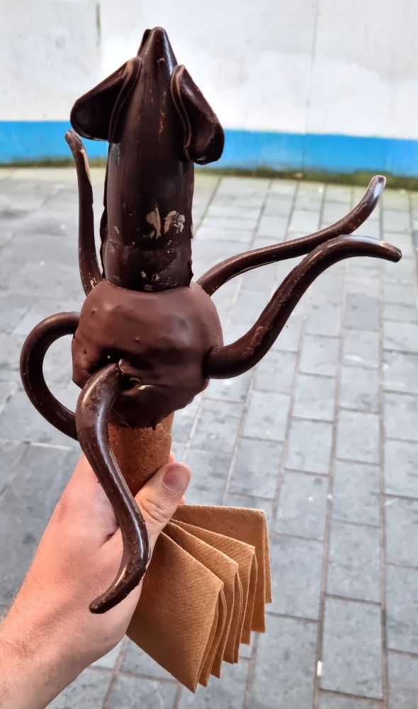 A squid shaped ice cream cone made from dark chocolate, a delightfully decadent treat.