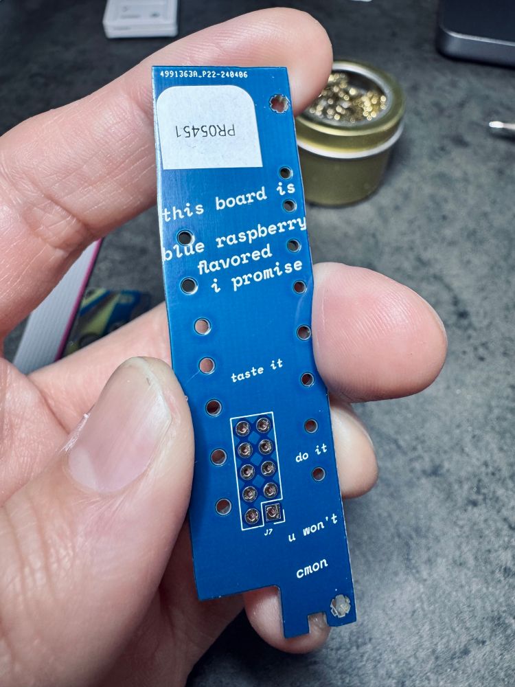 Blue LED lens PCB for the Pet Rock synth module, with the text, “this board is blue raspberry flavored  i promise, taste it, do it, u won’t, cmon”