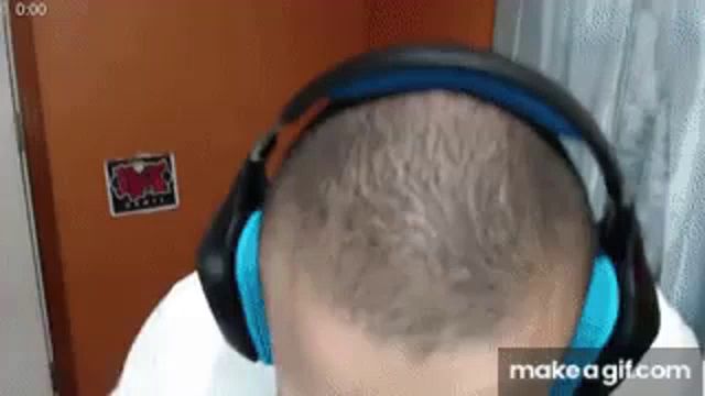 a man is wearing headphones on his head and has a tattoo on his head .