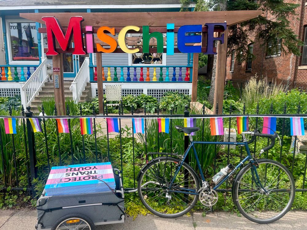 Bicycle with trailer full of signs in front of our store. 