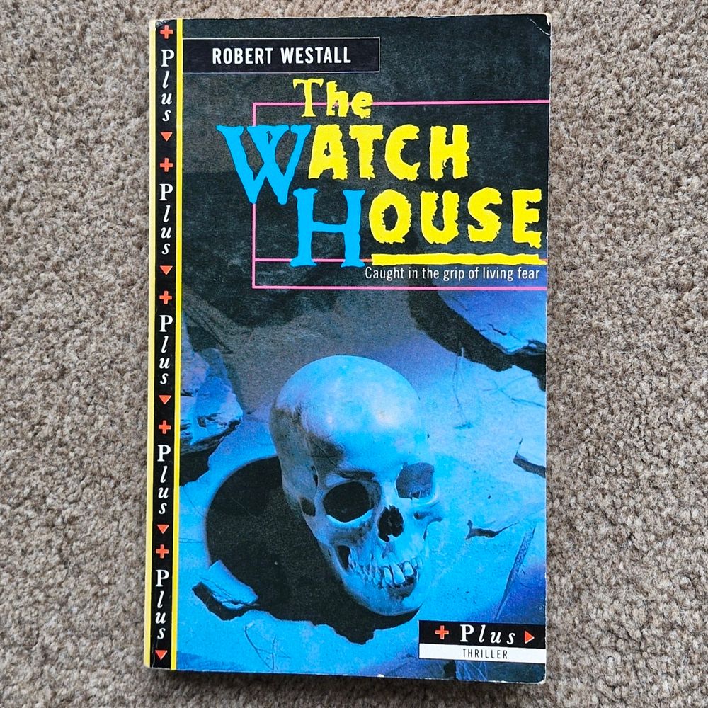 The cover of a small 1980s paperback - "The Watch House" by Robert Westell, which shows a skill on a dusty floor.