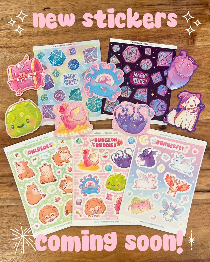 A flat display of 3 cute magical creature sticker sheets, 2 glittery polyhedral dice sticker sheets, and 7 sparkle holographic die cut stickers of various cute fantasy and d&d creature illustrations. Text reads "new stickers coming soon!"