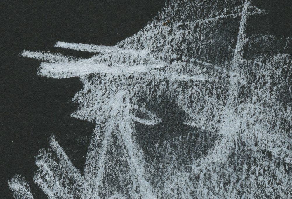 a scan of white charcoal scribbles on a dark paper background.