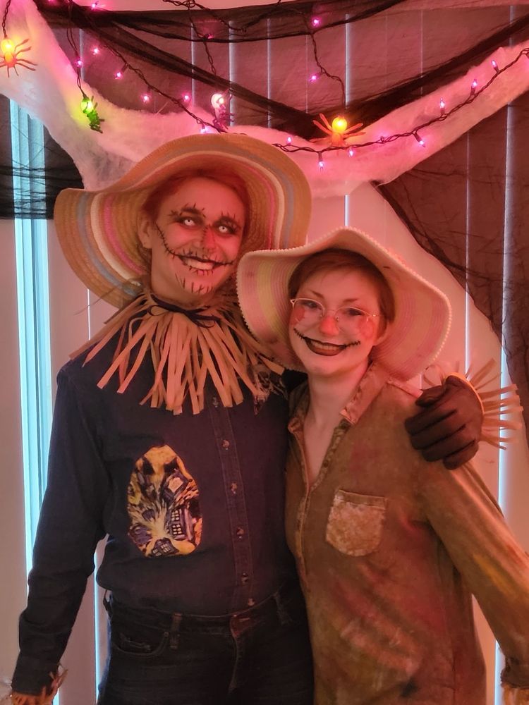 Closer image of Simon and Chloe as scarecrows. Chloe’s makeup is more cutesy, while Simon’s is more scary with glowing white contacts.