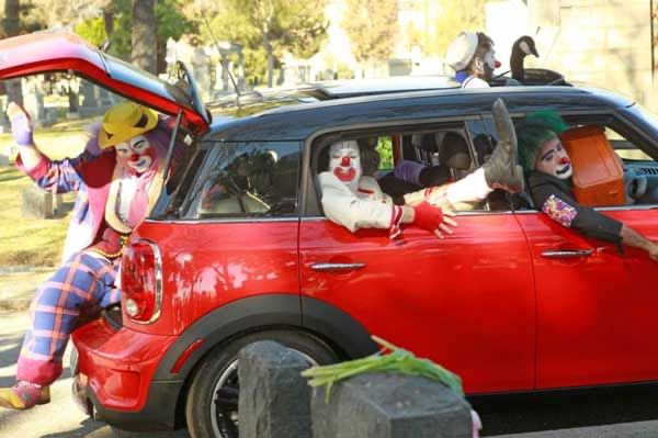 A small car that is just chock full of clowns.