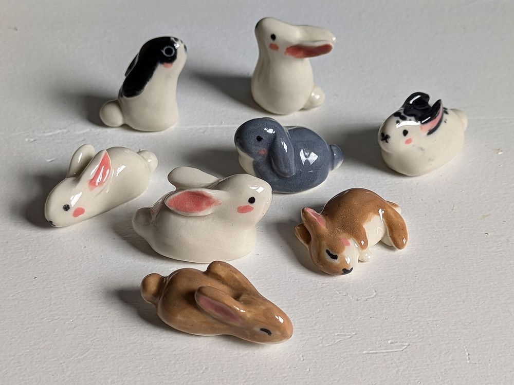 8 cute little bunny porcelain figurines in various positions, colors and shapes. 