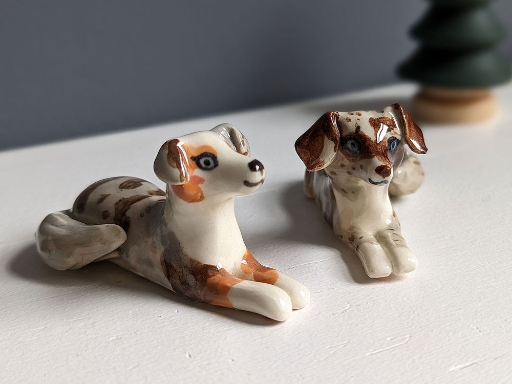 Custom figurines of two Australian shepherds sisters 