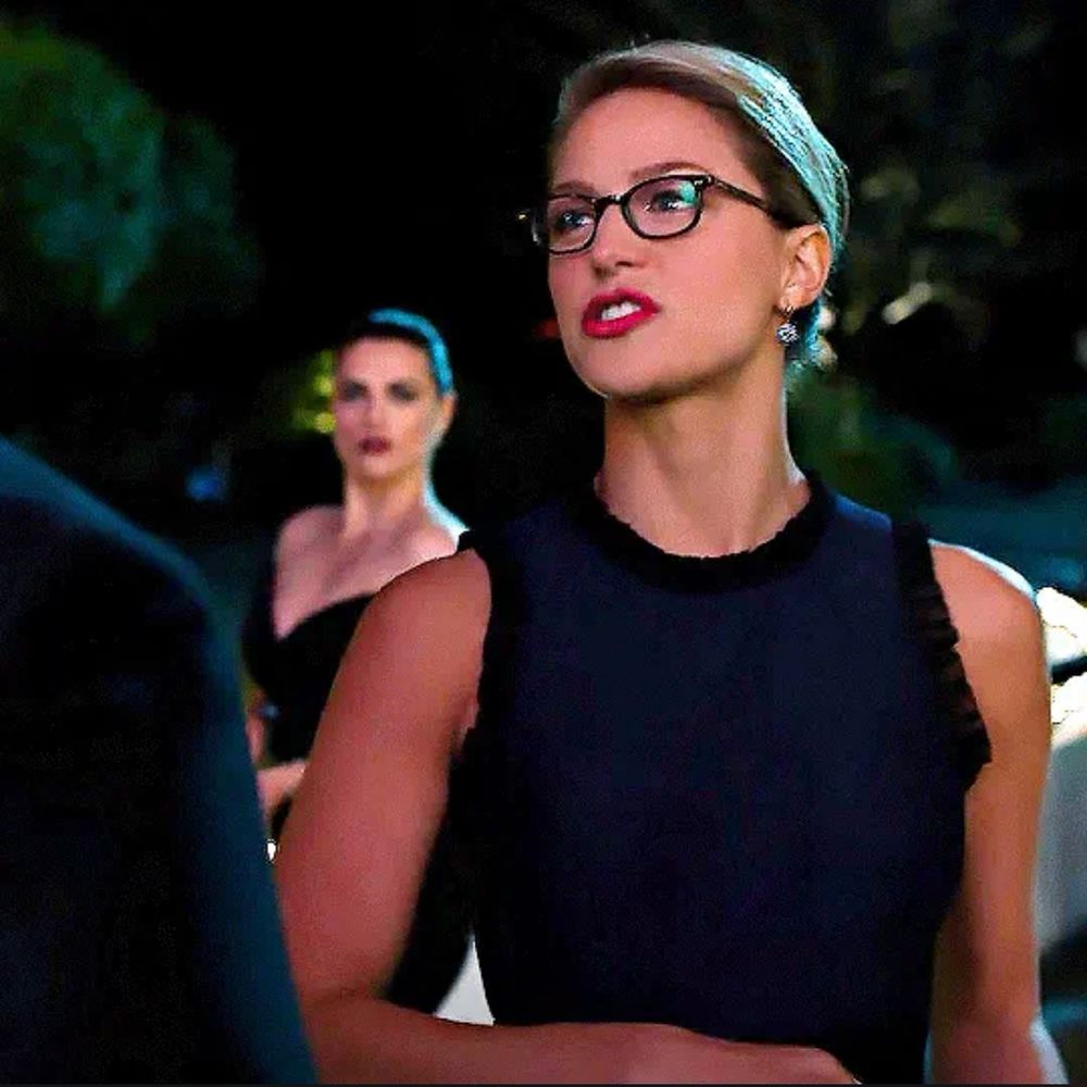 Lena sneaking in the background as Kara talks to the bouncer. 