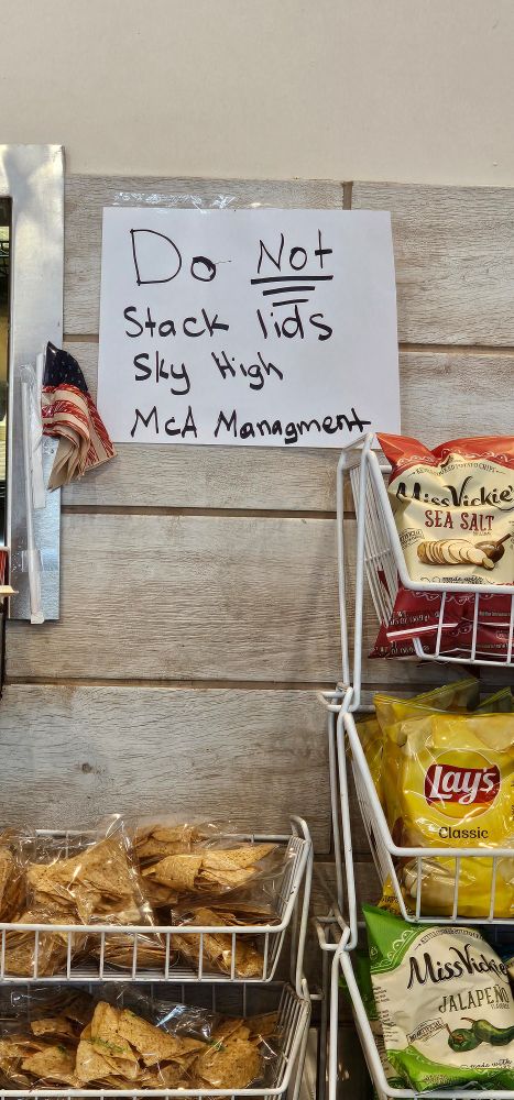 Handwritten sign "Do not stack lids sky high McA Managment"