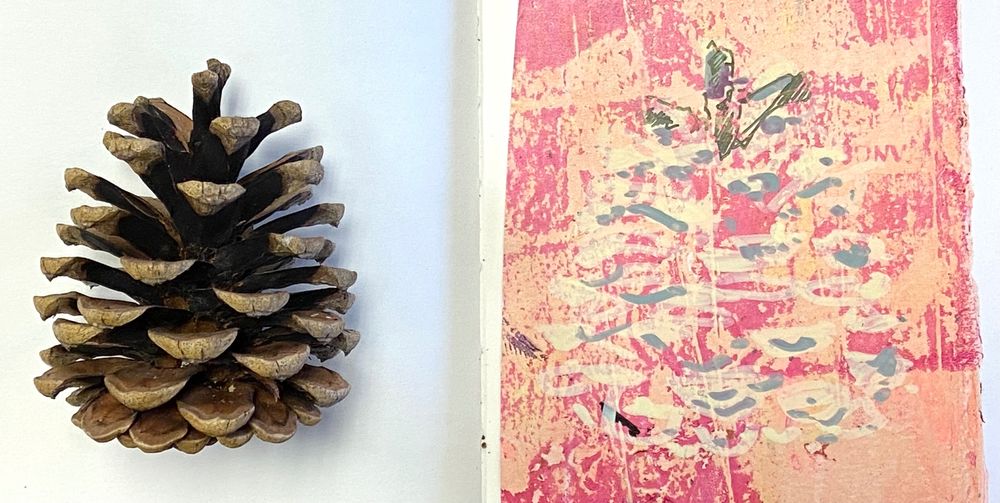 Pine cone on left, next to an unfinished drawing of the same - on pink/peach coloured, gel printed paper. Beginnings of cone mapped out in acrylic pen line.
