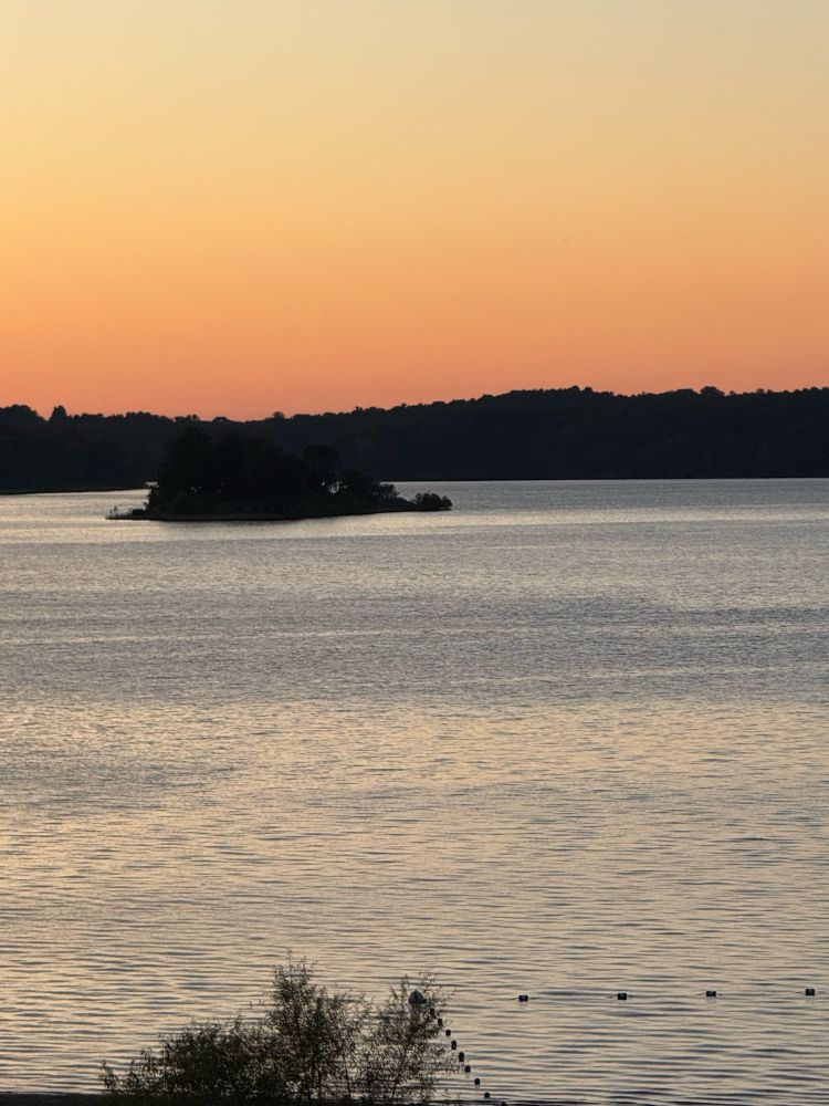 Island surrounded by water and twilight