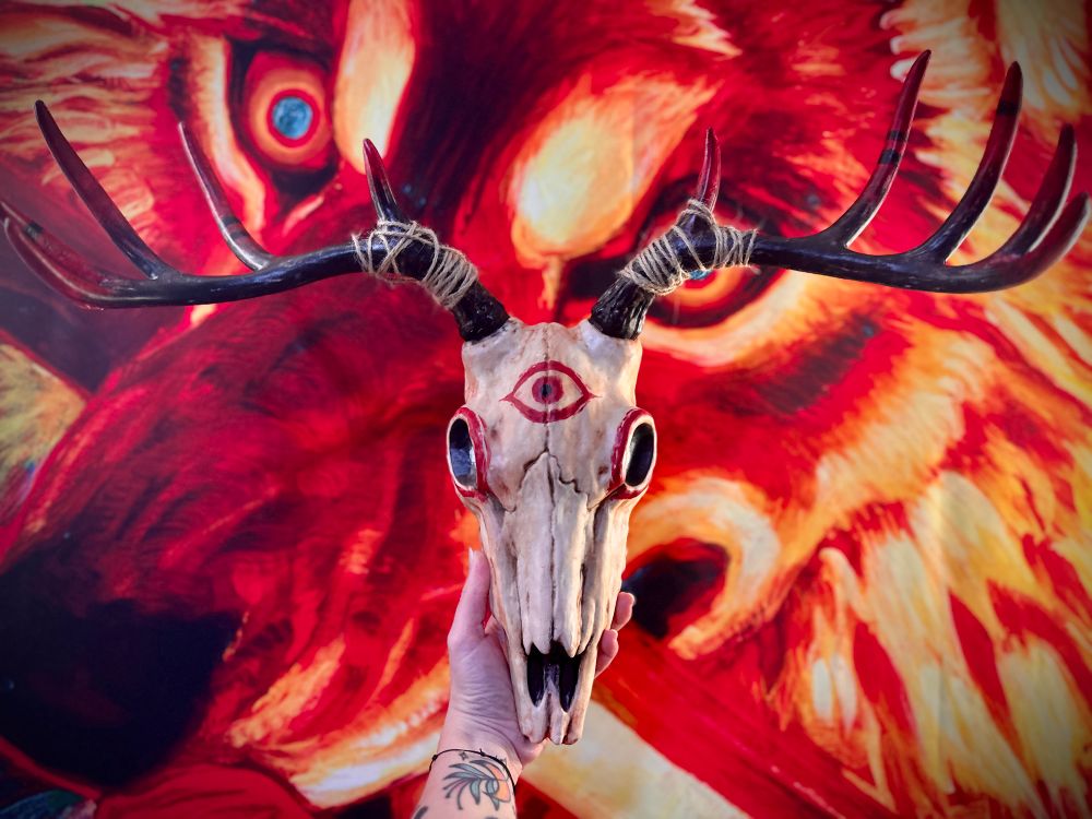 plastic deer skull with antlers painted black and red 