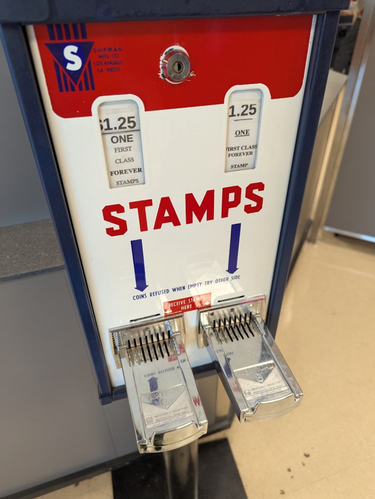 photo of a very old coin-operated mail stamp dispenser