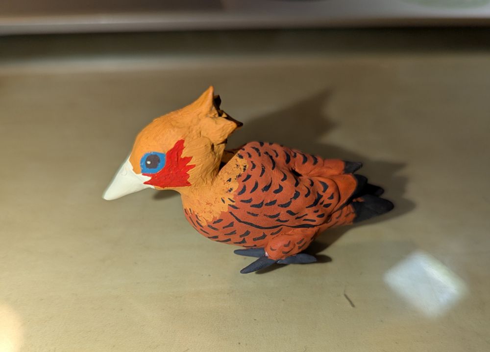 photo of a clay sculpture of a male chestnut-colored woodpecker