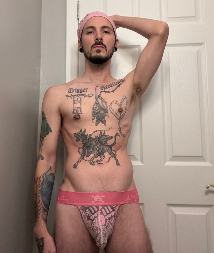 Myself in a pink see through jock strap, and pink bandana, with arm behind my head exposing my armpit. 