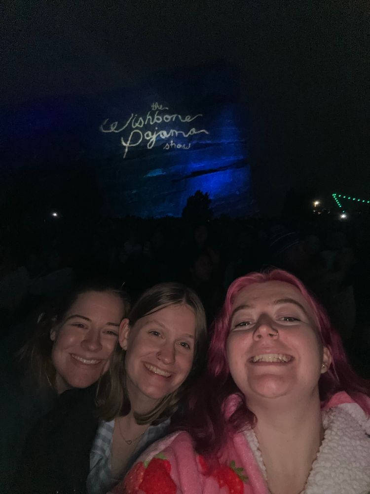 3 girls in front of a giant rock that says “the wishbone pajama show”