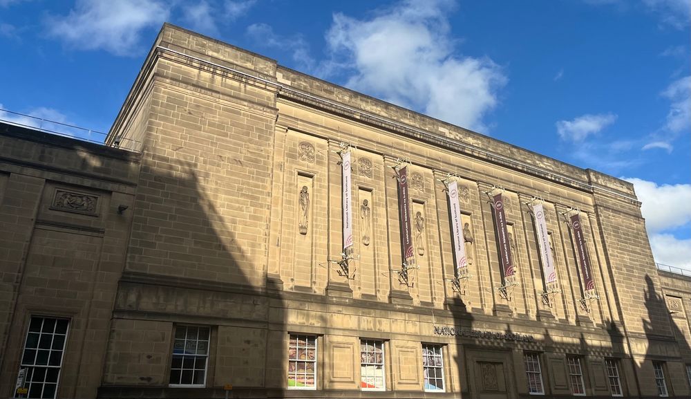Photo of the National Library of Scotland building, with a focus on the upper part of the building and its windows. 