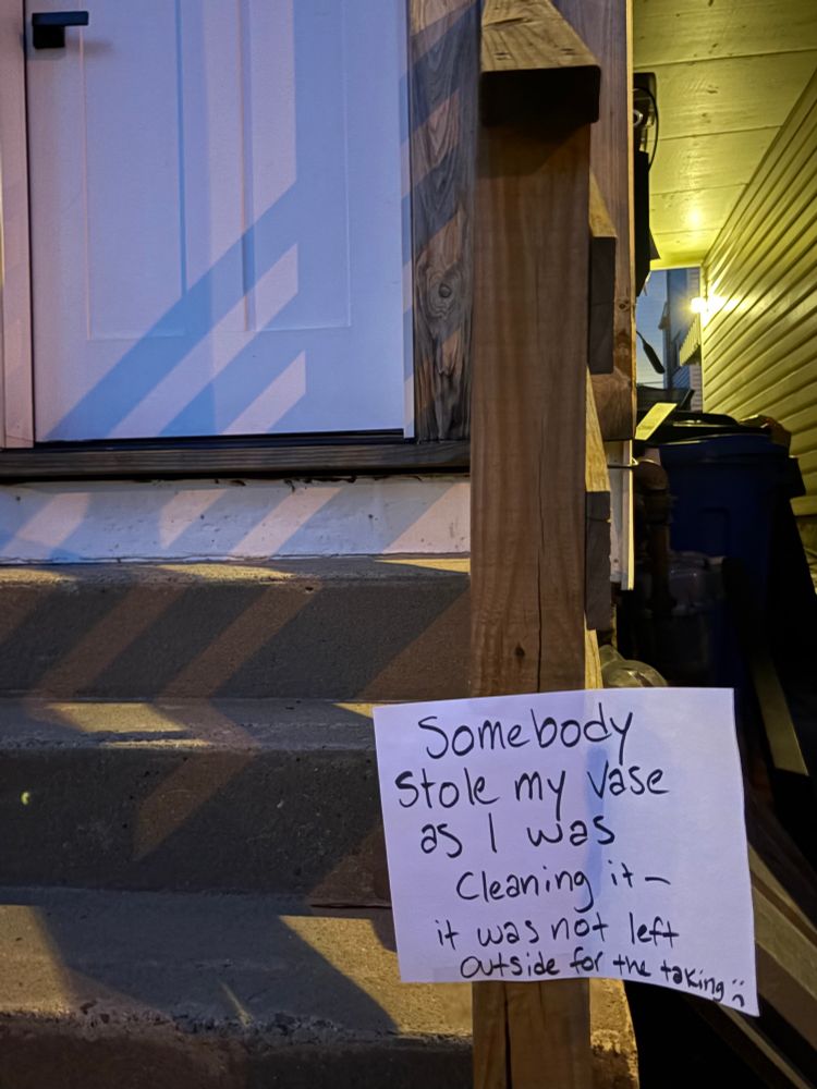 handwritten note on outside stairs indicating a vase that had been left outside and taken was not up for grabs y’all