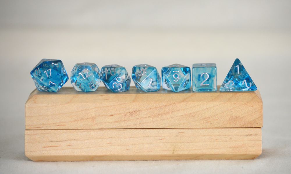  Blue and crystal polyhedral dice set for Dungeons & Dragons, featuring glittering resin and silver numbering; perfect for water-themed D&D characters and TTRPG spellcasters.